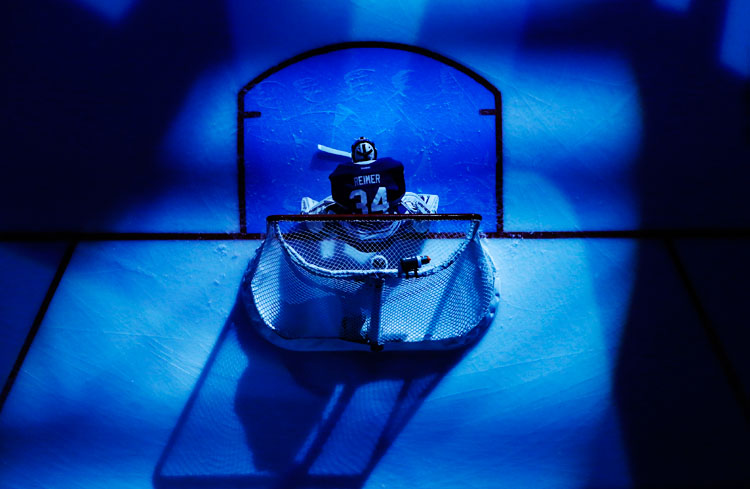 Maple Leafs goalie Reimer is seen in the pre-game spotlight before his team plays the Bruins during their NHL hockey game in Toronto